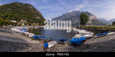 Boats at Valmedrera harbour on Lake Como, Italy, with mountains Stock Photo