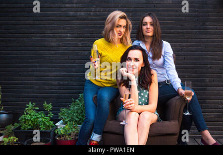 Group of partying girls with flutes with sparkling wine having fun on the party Stock Photo