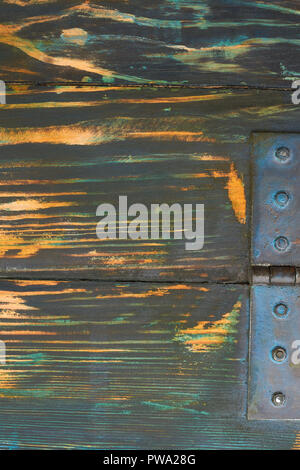 Door hinge on the wooden boards. Dark horizontal wooden planks with hinge. Old vintage fence close up. Stock Photo