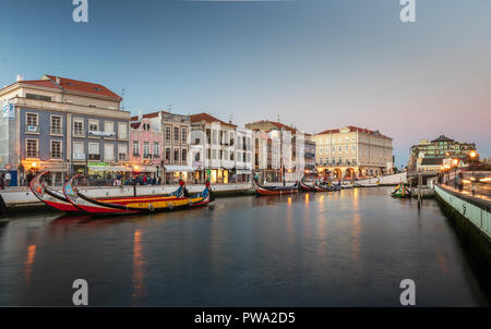 Aveiro, Portugal. July 28, 2018. Central canal in Aveiro, with several moliceiros anchored and houses Art Noveau in the background at dusk. Center of  Stock Photo