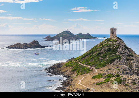 View of Pointe de la Parata on the west coast of Corsica. A ruined Genoese tower sits on top of the rocky promontory overlooking the Sanguinaires. Stock Photo