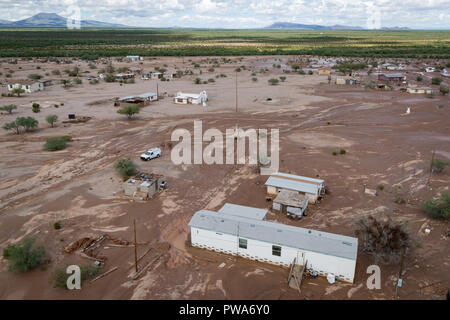 Homes covered with mud from flooding caused by heavy rains from Tropical Storm Rosa in the Tohono O'odham Indian Reservation October 3, 2018 in Ali Chuk, Arizona. Stock Photo