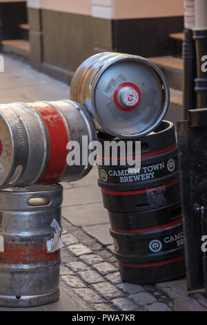 Casks of Guinness and Camden Town Brewery barrels are stacked on the street to be changed and brought in the cellars of a Greenwich pub in London UK.