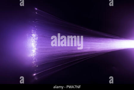 optical fibres dinamic flying from deep on technology background Stock Photo