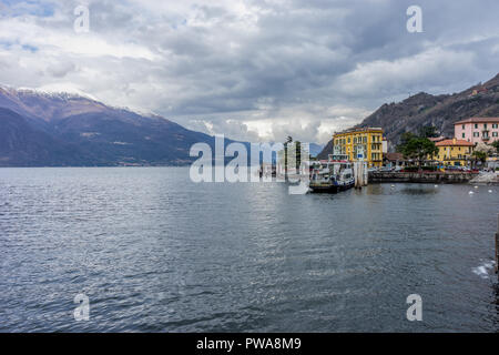 Varenna, Italy- March 31, 2018: A boat on Lake Como transporting cars to the village of Varenna Stock Photo