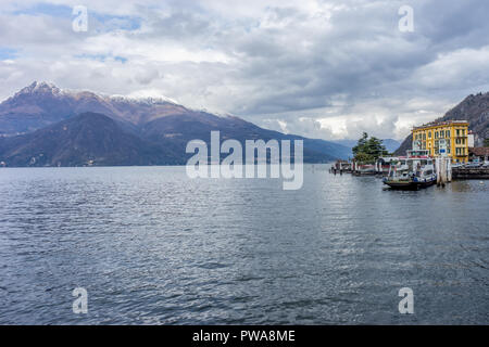Varenna, Italy- March 31, 2018: A boat on Lake Como transporting cars to the village of Varenna Stock Photo