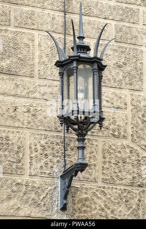Decorative wrought iron lamp on sandstone house wall, Pistoia, Tuscany, Italy, Europe, Stock Photo