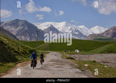 Bicyclists along the Pamir Highway, Kyrgyzstan Stock Photo