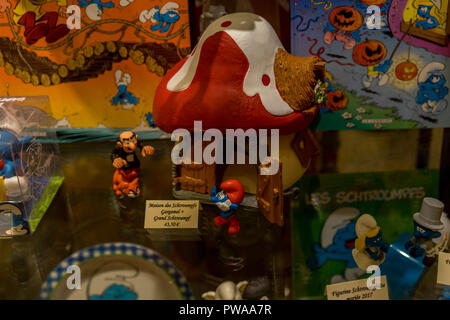 Brussels, Belgium - April 17 : Smurfs comics and sculptures are displayed in a window of a shop in Brussels, Belgium, Europe on April 17, 2017 Stock Photo