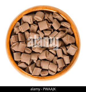 Chocolate chunks in wooden bowl. Milk chocolate pieces for baking and decorating of cookies, muffins and brownies. Edible baking igredient. Stock Photo