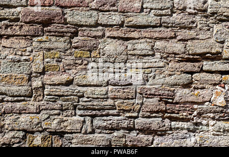 Weathered grey stone wall as creative background texture Stock Photo