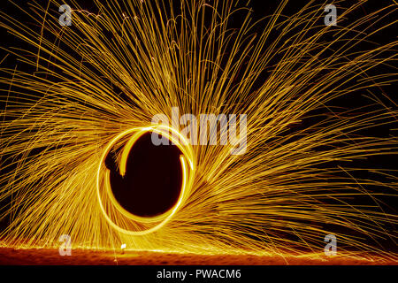 fire dance on beach near the sea , the east coast of thailand Stock Photo