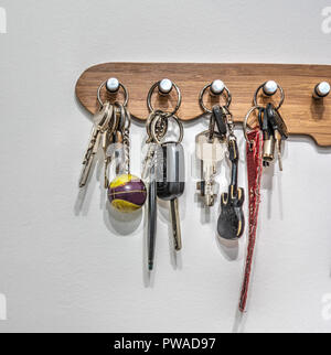 Key holder with keys hanging on the wall Stock Photo
