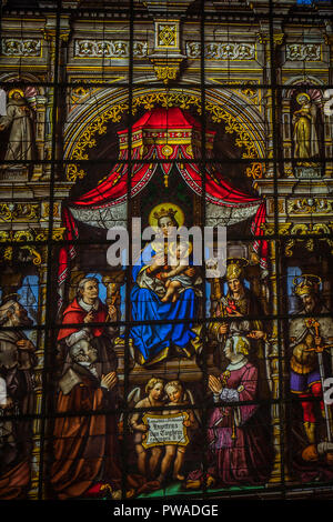 Painted glass with Mary and baby Jesus in the interiors of Saint Nicholas Church, Ghent, Belgium, Europe Stock Photo