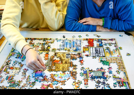 Mother and daughter doing a jigsaw puzzle together Stock Photo