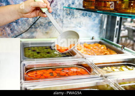 Set of fruit dessert for make a smoothie. Fresh fruits juices. The woman's hand making smoothie fruit, takes with ladle the fruit juice from the water Stock Photo