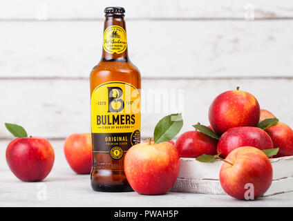 LONDON, UK - SEPTEMBER 13, 2018: Bottle of Bulmers Original Cider with fresh apples on wood background. Stock Photo