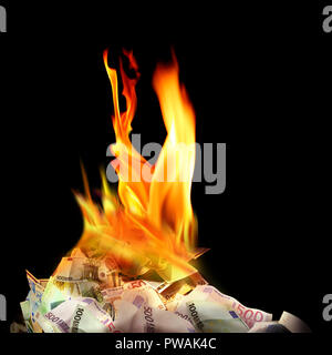 Conceptual finance image of burning pile of money, dollar and euro bills, with fire flames in black background Stock Photo