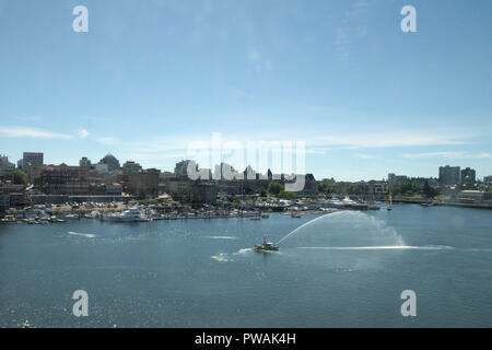 Fire boat spraying in Victoria inner harbour, British Columbia, Canada Stock Photo