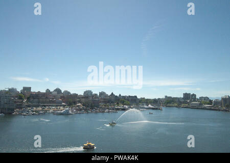 Fire boat spraying in Victoria inner harbour, British Columbia, Canada Stock Photo