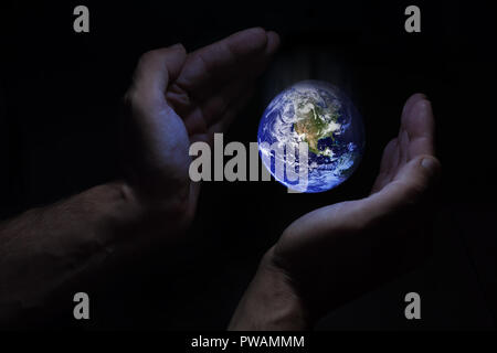 Terrestrial globe dropped: concept of neglect of world conservation. Elements of this image furnished by NASA. Stock Photo