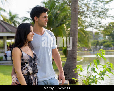 Young Hispanic couple relaxing in the park together Stock Photo