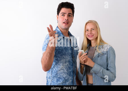 Young Persian man and beautiful blond woman against white backgr Stock Photo