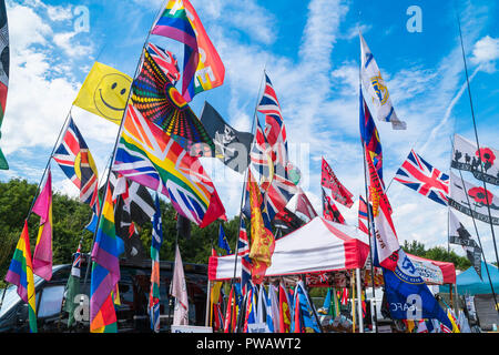 Flags and banners on a country show stall blowing in the wind. Stock Photo