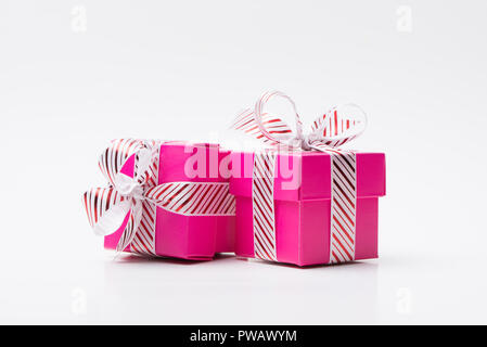 Two pink gift box tied with white red stripe ribbon Stock Photo