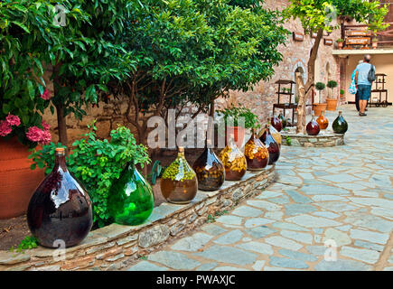 Traditional 'homemade' liquers in the courtyard of Evangelistria Monastery ('Monastery of the Annunciation'), Skiathos island, North Sporades, Greece. Stock Photo