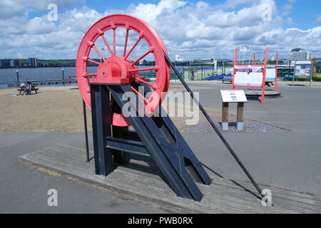 Pithead wheel, from Bettws drift mine, Ammanford, Wales, now part of the Welsh coal mining heritage display, Cardiff Bay, Glamorgan, South Wales, UK Stock Photo