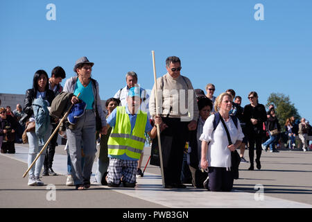 Pilgrims crawling on their knees in penance at the Sanctuary of Our Lady of Fatima, Portugal, Europe Stock Photo