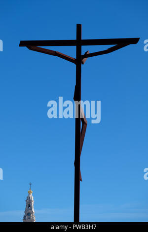 34 metres tall weathered steel cross with Jesus Christ by german sculptor Robert Schad at the Sanctuary of Our Lady of Fatima, Fátima, Portugal Stock Photo