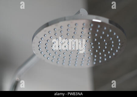 Close up of a stainless steel overhead shower head with modern contemporary design Stock Photo