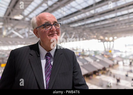 Overweight senior businessman lounging around the airport of Ban Stock Photo