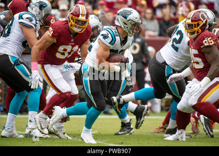 Carolina Panthers running back Christian McCaffrey (22) carries the ball in the first quarter against the Washington Redskins at FedEx Field in Landover, Maryland on October, 2018. Washington Redskins linebacker Ryan Kerrigan (91) and defensive tackle Da'Ron Payne (95) defend on the play. Credit: Ron Sachs/CNP | usage worldwide Credit: dpa picture alliance/Alamy Live News Stock Photo