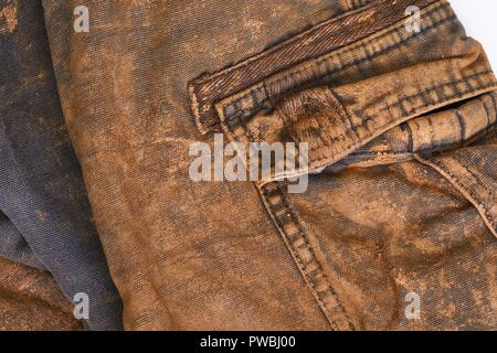 Stained Jeans. Muddy jeans on a washing machine. Mud stain on jeans. Stained  jeans before laundry. Metaphore for embarrassment, guilt, shame Stock Photo  - Alamy