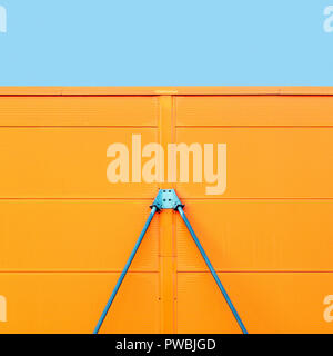 Colorful metal construction detail of industrial architecture with blue sky on the top, geometric abstract background picture Stock Photo