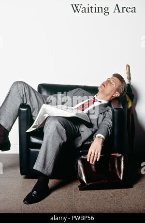 Businessman tormented by long wait in waiting room, USA Stock Photo