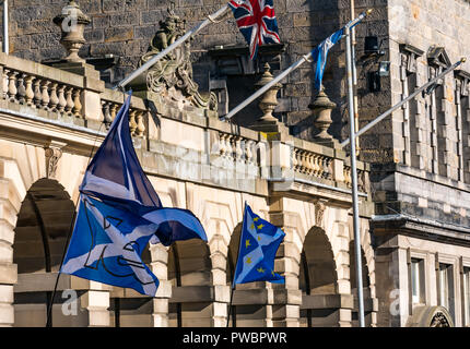 Saltire flags waving at All Under One Banner Scottish Independence march 2018, City Chambers, Royal Mile, Edinburgh, Scotland, UK Stock Photo