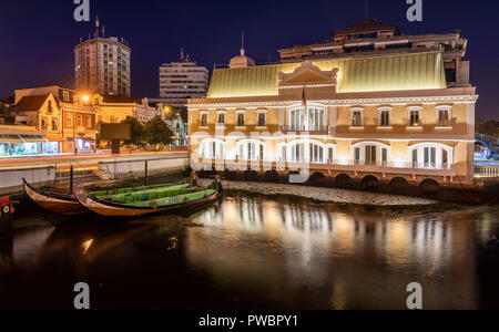 View of the central canal in Aveiro at night with moliceiros moored and building illuminated. City center of Aveiro in Portugal. Stock Photo