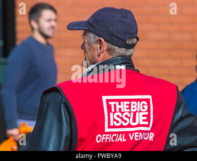 The Big Issue official vendor at Bournemouth, Dorset UK in October Stock Photo