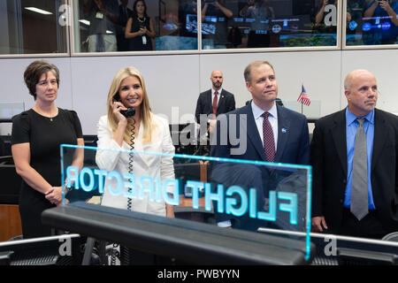 Ivanka Trump, daughter of President Donald Trump, speaks to the crew aboard the International Space Station during a visit to the Mission Control Center at the Johnson Space Center September 20, 2018 in Houston, Texas. Standing with Ivanka Trump are NASA Administrator Jim Bridenstine, center, and Johnson Center Director Mark Geyer, right. Stock Photo