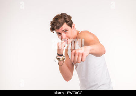 People, sport and gesture concept - young man boxing on white background with copy space Stock Photo