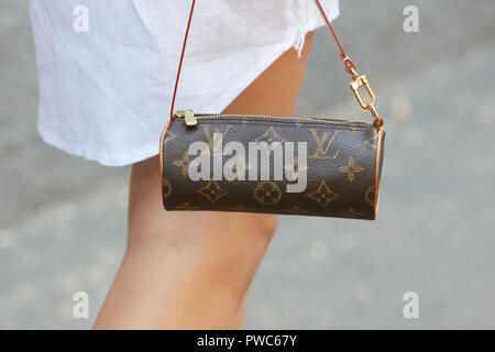 MILAN, ITALY - SEPTEMBER 20, 2019: Woman with brown Louis Vuitton checkered  bag, white dress and Dior bracelets before Sportmax fashion show, Milan Fa  Stock Photo - Alamy