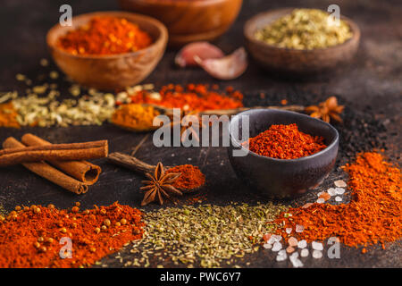 Different kind of spices in wooden bowls on dark background. Food background. Stock Photo