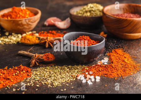 Different kind of spices in wooden bowls on dark background. Food background. Stock Photo