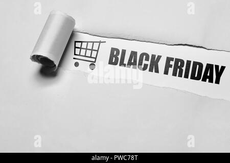 Black Friday message appering behind ripped paper. Black friday concept Stock Photo