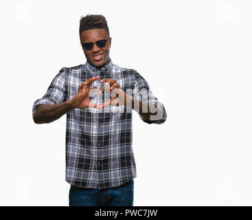 Young african american man wearing sunglasses over isolated background smiling in love showing heart symbol and shape with hands. Romantic concept. Stock Photo