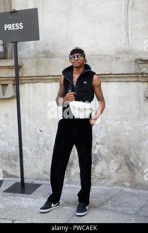 MILAN - SEPTEMBER 20: Man with black Louis Vuitton backpack and